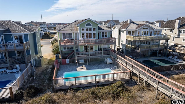 4939 S Virginia Dare Trl Lot 4, Nags Head, NC 27959 - rear view of house with a residential view, a fenced backyard, and a community pool