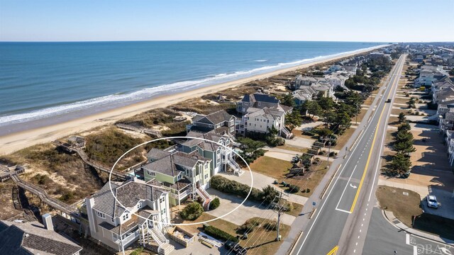 drone / aerial view featuring a water view and a view of the beach