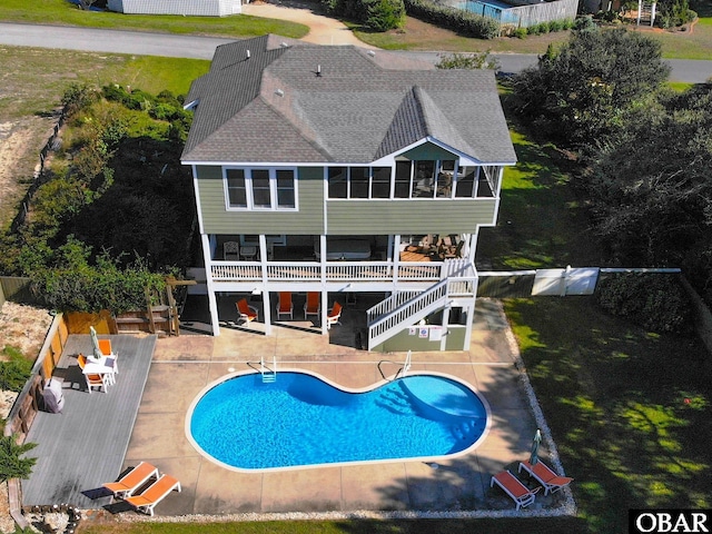 back of house featuring a patio, a fenced backyard, roof with shingles, stairs, and a deck