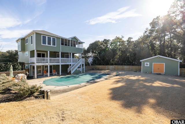 view of pool featuring a fenced in pool, a patio, stairway, fence, and an outdoor structure