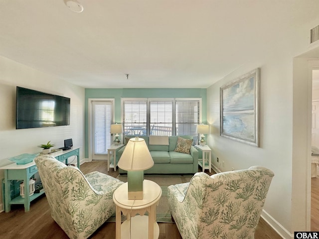 living room with dark wood-style flooring and baseboards