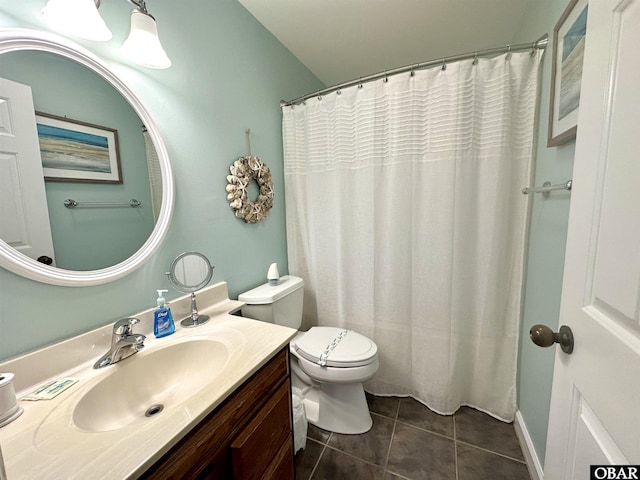 bathroom featuring toilet, tile patterned flooring, and vanity