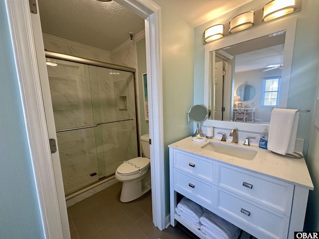 full bathroom featuring a textured ceiling, a stall shower, vanity, and toilet