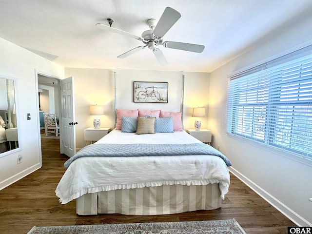 bedroom featuring a ceiling fan, baseboards, and dark wood-type flooring