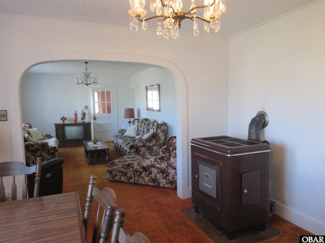 living area with arched walkways, dark carpet, and a chandelier