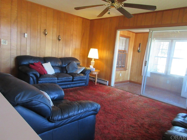 carpeted living room with a baseboard radiator, wooden walls, and ceiling fan