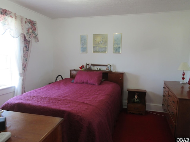 bedroom featuring dark colored carpet