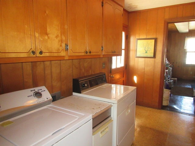 laundry area featuring laundry area, independent washer and dryer, and wooden walls