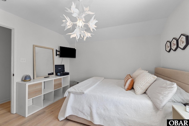 37 Foxwood Cir Lot # 33, Southern Shores, NC 27949 - bedroom with light wood-type flooring, vaulted ceiling, and a chandelier