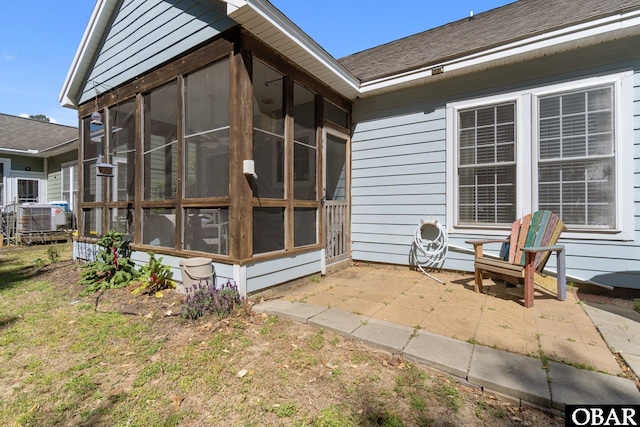 37 Foxwood Cir Lot # 33, Southern Shores, NC 27949 - rear view of house featuring a sunroom, a patio area, central AC unit, and a shingled roof