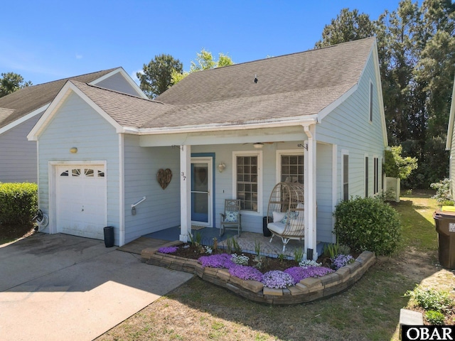 37 Foxwood Cir Lot # 33, Southern Shores, NC 27949 - view of front of house with a porch, an attached garage, concrete driveway, and roof with shingles