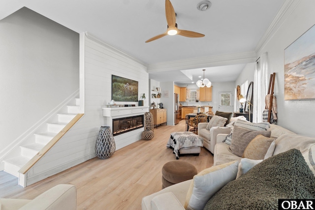 37 Foxwood Cir Lot # 33, Southern Shores, NC 27949 - living room featuring ornamental molding, ceiling fan, light wood-type flooring, stairs, and a glass covered fireplace