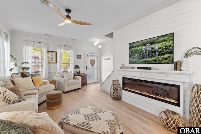 37 Foxwood Cir Lot # 33, Southern Shores, NC 27949 - living room featuring a glass covered fireplace, a ceiling fan, crown molding, wood finished floors, and wood walls