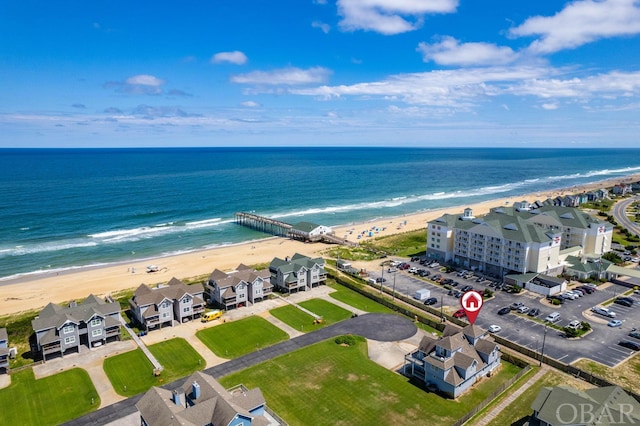 drone / aerial view featuring a water view and a beach view