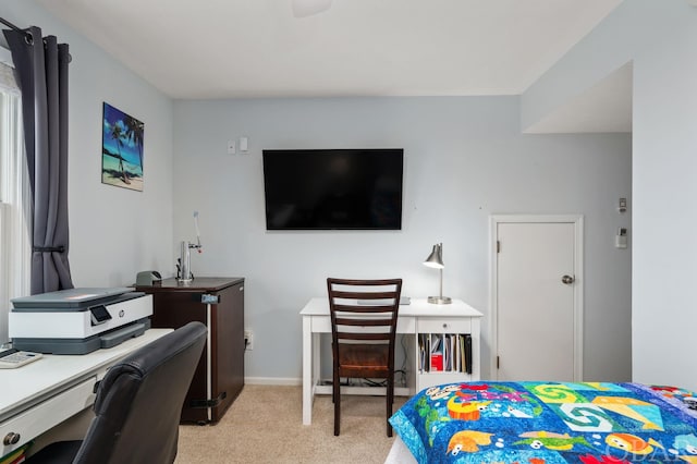 bedroom featuring light carpet and baseboards