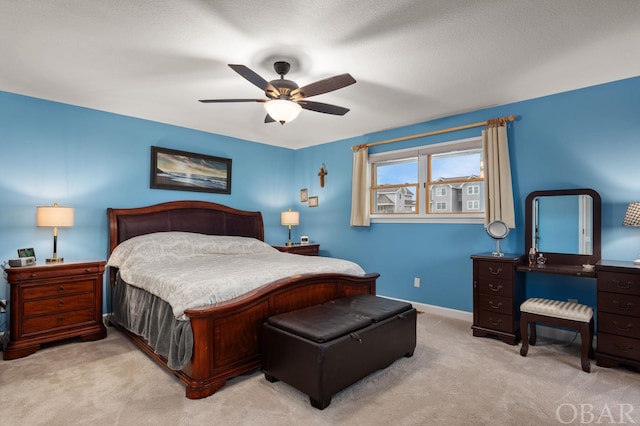 bedroom with light carpet, ceiling fan, and baseboards