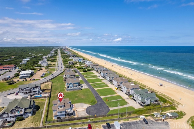 drone / aerial view with a water view and a view of the beach