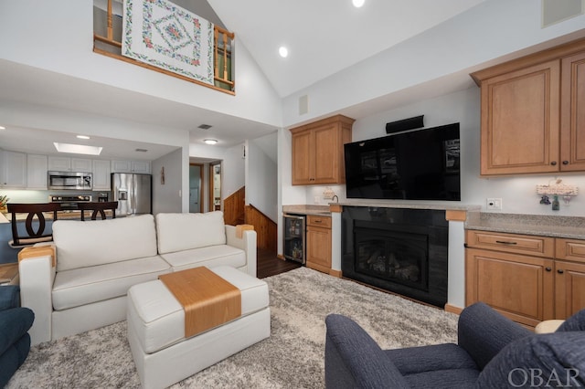 living room featuring high vaulted ceiling, wine cooler, visible vents, and recessed lighting