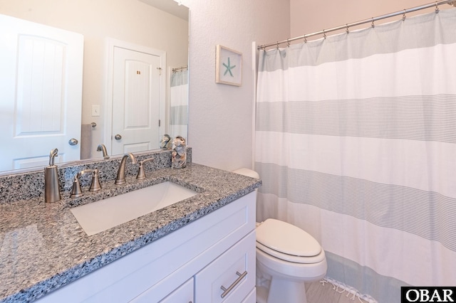 full bathroom with vanity and toilet