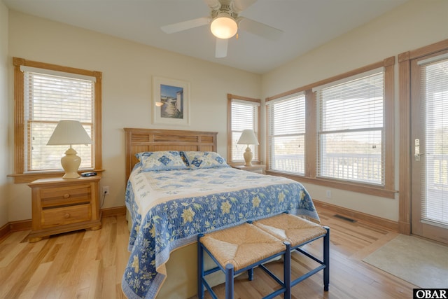 bedroom featuring baseboards, visible vents, a ceiling fan, and light wood finished floors