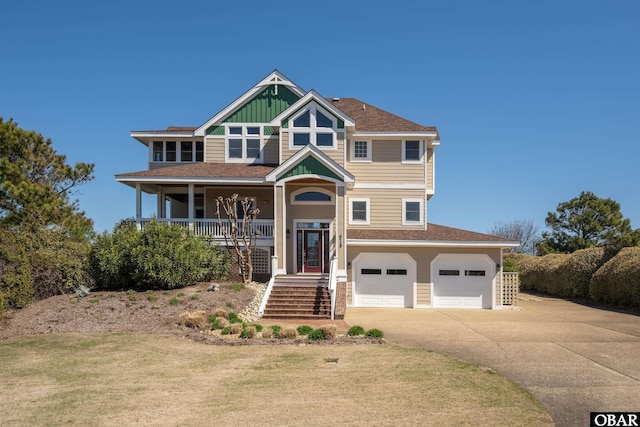 view of front of property with a front yard, stairway, concrete driveway, a garage, and a porch