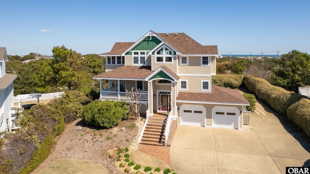 view of front of home featuring stairs, concrete driveway, roof with shingles, and an attached garage