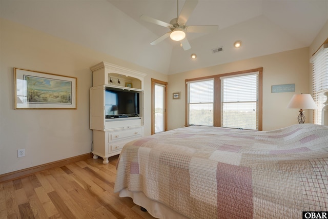 bedroom featuring a ceiling fan, light wood finished floors, lofted ceiling, baseboards, and visible vents