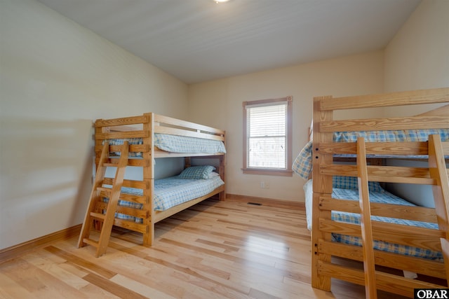 bedroom with baseboards and wood finished floors