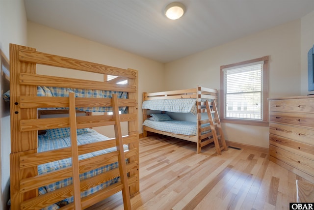 bedroom with baseboards and wood finished floors
