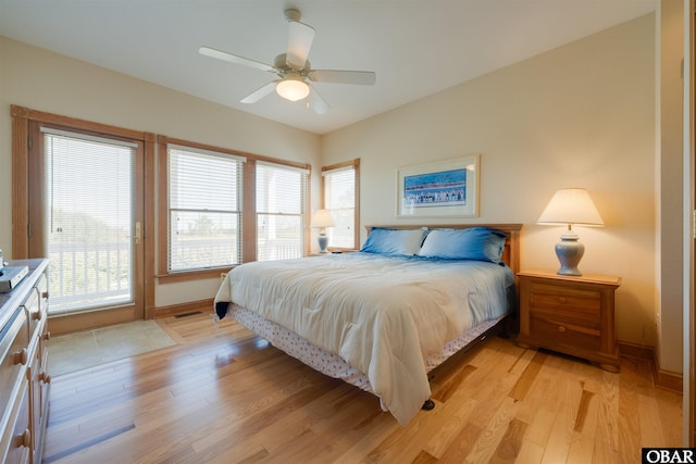 bedroom with a ceiling fan, baseboards, and light wood-type flooring