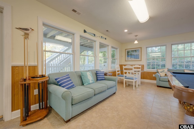 1278 Bear Foot Path Lot 250, Corolla, NC 27927 - living room with healthy amount of natural light, wainscoting, wooden walls, and recessed lighting