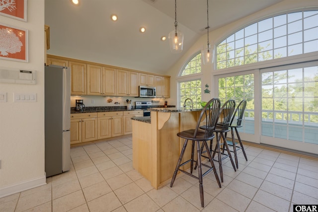 1278 Bear Foot Path Lot 250, Corolla, NC 27927 - kitchen with stainless steel appliances, light brown cabinets, recessed lighting, a breakfast bar area, and light tile patterned floors