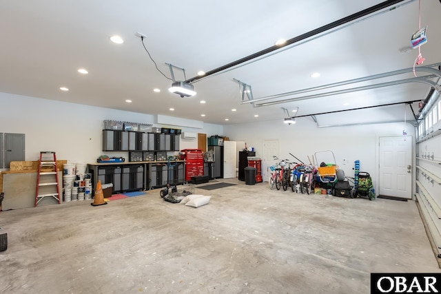 830 Hunt Club Dr Lot 387R, Corolla, NC 27927 - garage featuring a garage door opener, recessed lighting, and electric panel