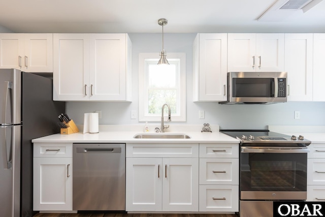 830 Hunt Club Dr Lot 387R, Corolla, NC 27927 - kitchen featuring light countertops, white cabinetry, appliances with stainless steel finishes, and a sink
