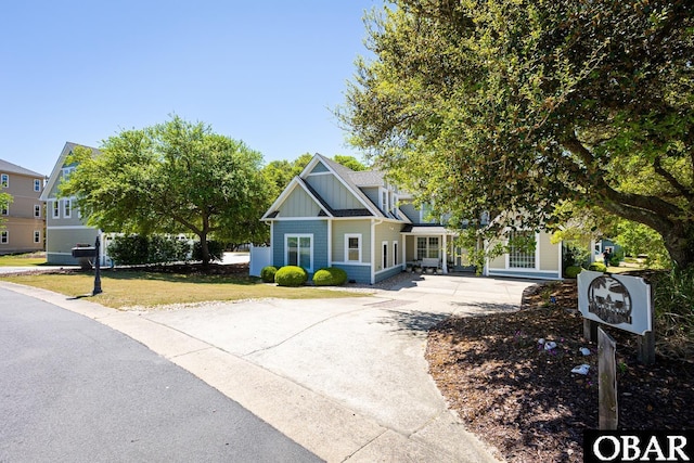 830 Hunt Club Dr Lot 387R, Corolla, NC 27927 - view of front of home featuring board and batten siding, driveway, and a front lawn