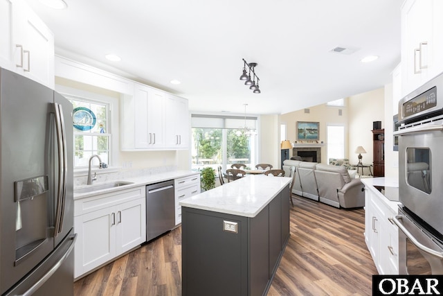 830 Hunt Club Dr Lot 387R, Corolla, NC 27927 - kitchen with a sink, stainless steel appliances, white cabinetry, a kitchen island, and visible vents