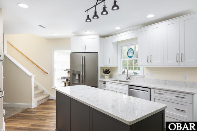 830 Hunt Club Dr Lot 387R, Corolla, NC 27927 - kitchen featuring a center island, white cabinetry, light stone counters, a sink, and appliances with stainless steel finishes