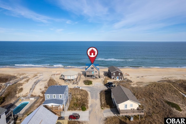 drone / aerial view with a water view and a view of the beach