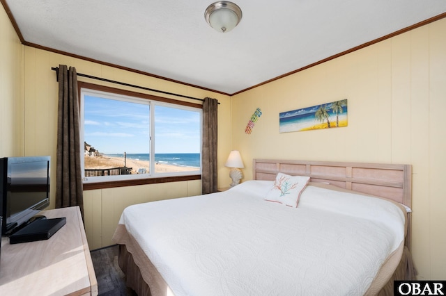 bedroom with a water view and crown molding