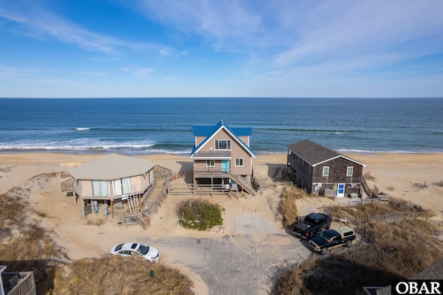 birds eye view of property with a view of the beach and a water view