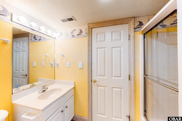25224 Mac Oca Dr Lot 24, Waves, NC 27982 - full bath with a textured ceiling, vanity, and a shower with shower door