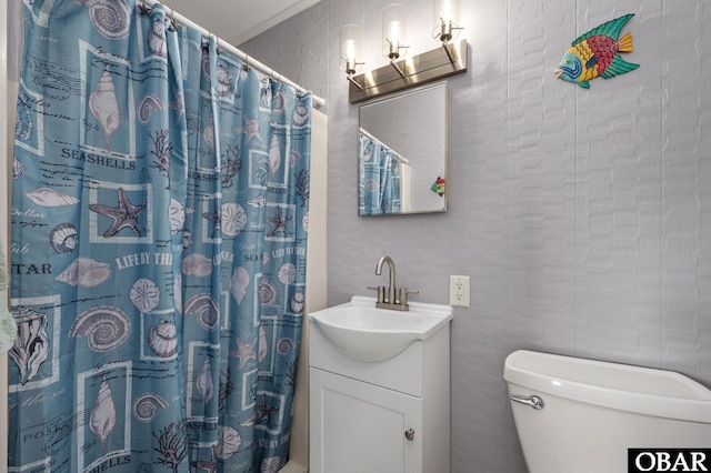 bathroom featuring curtained shower, vanity, and toilet