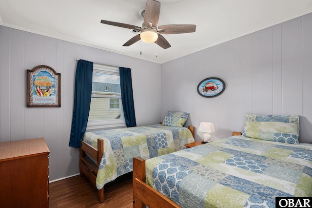 bedroom featuring ceiling fan, ornamental molding, and dark wood-style flooring