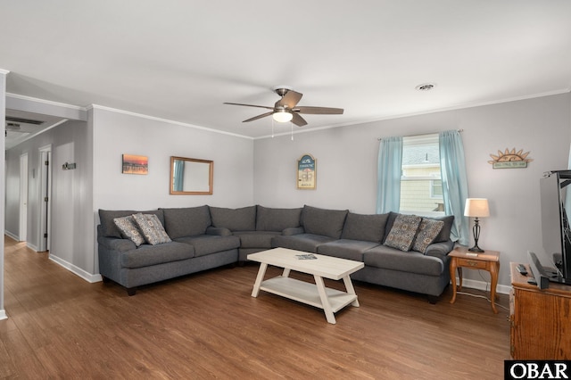 living room featuring dark wood-type flooring, visible vents, and crown molding