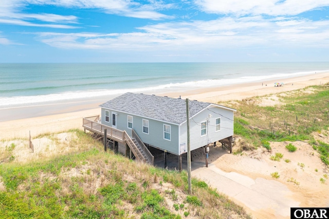 birds eye view of property with a beach view and a water view