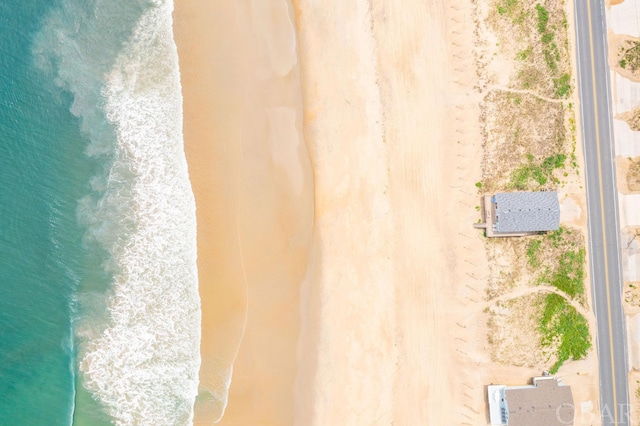 bird's eye view featuring a water view and a view of the beach