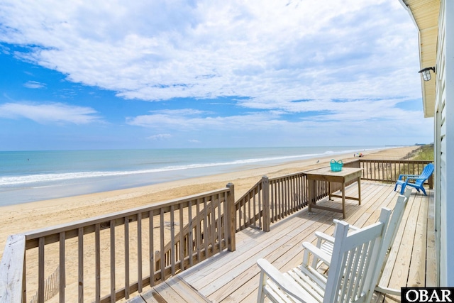 wooden terrace with a water view and a beach view