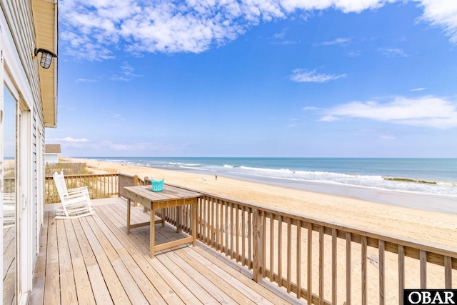 wooden terrace with a beach view and a water view