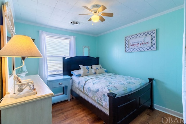 bedroom with ceiling fan, dark wood finished floors, visible vents, and crown molding