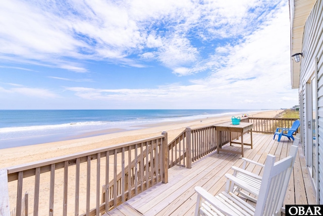 deck featuring a view of the beach and a water view